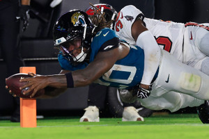 Jacksonville Jaguars running back Deejay Dallas (20) is three yards shy as Tampa Bay Buccaneers safety Rashad Wisdom (38) forces
